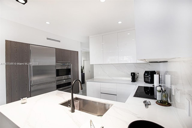 10857 NW 84th St, Doral, FL 33178 - kitchen featuring modern cabinets, stainless steel appliances, white cabinets, decorative backsplash, and recessed lighting