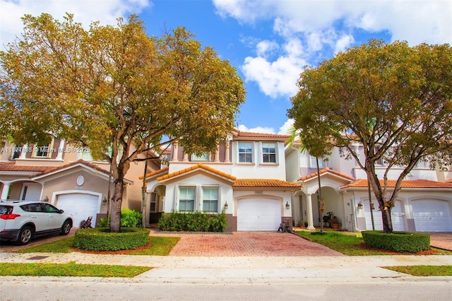 10857 NW 84th St, Doral, FL 33178 - mediterranean / spanish house featuring decorative driveway, stucco siding, and a tile roof