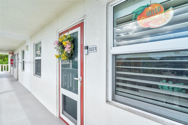 3021 Ellesmere B 3021, Deerfield Beach, FL 33442 - view of exterior entry with stucco siding and covered porch