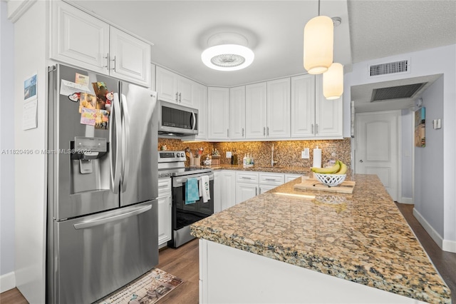 3021 Ellesmere B 3021, Deerfield Beach, FL 33442 - kitchen with appliances with stainless steel finishes, white cabinets, decorative backsplash, and dark wood finished floors