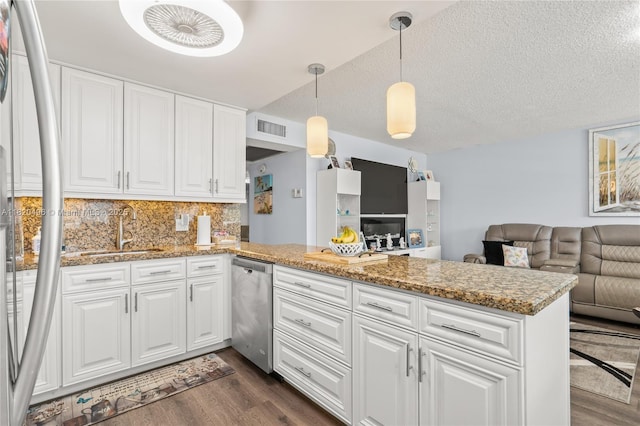 3021 Ellesmere B 3021, Deerfield Beach, FL 33442 - kitchen featuring stainless steel dishwasher, dark wood finished floors, a peninsula, open floor plan, and white cabinetry