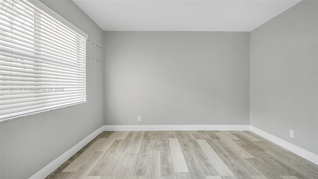 17901 NW 68th Ave Unit Q102, Hialeah, FL 33015 - spare room featuring light wood-type flooring and baseboards