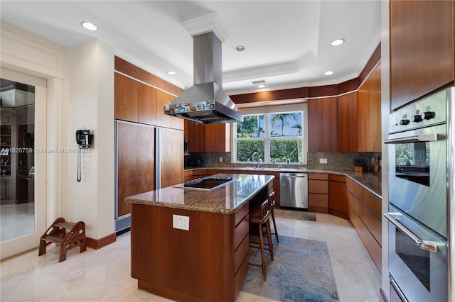 180 Solano Prado, Coral Gables, FL 33156 - kitchen featuring stainless steel appliances, island range hood, modern cabinets, brown cabinetry, and backsplash