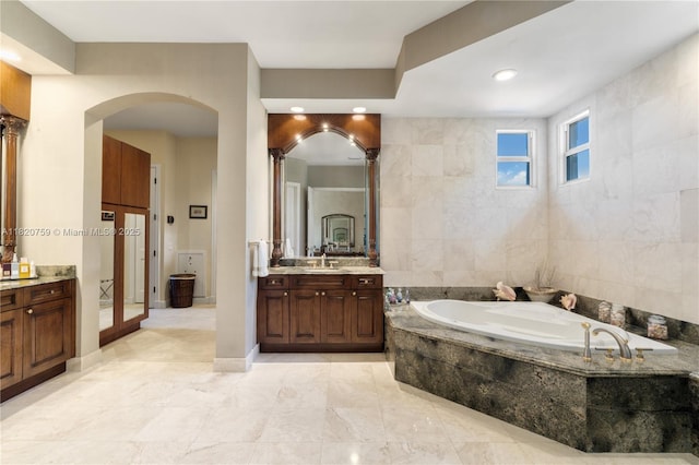 180 Solano Prado, Coral Gables, FL 33156 - bathroom with vanity, a bath, tile patterned floors, and tile walls