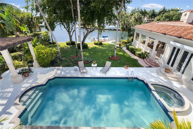 180 Solano Prado, Coral Gables, FL 33156 - view of swimming pool featuring a patio, a lawn, a water view, and a pool with connected hot tub