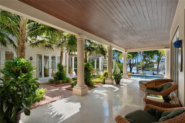 180 Solano Prado, Coral Gables, FL 33156 - view of patio / terrace with french doors, an outdoor pool, and a water view