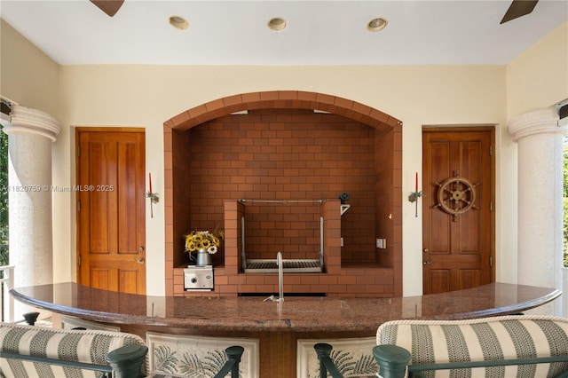 180 Solano Prado, Coral Gables, FL 33156 - kitchen featuring dark stone counters, recessed lighting, and ornate columns