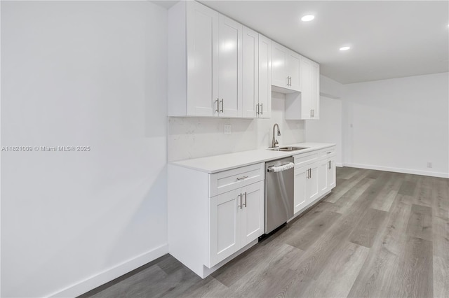 6675 NW 15th St, Margate, FL 33063 - kitchen with stainless steel dishwasher, light wood-style flooring, white cabinetry, light countertops, and recessed lighting