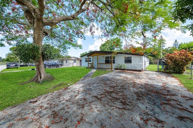 5736 Simms St, Hollywood, FL 33021 - kitchen featuring white appliances, under cabinet range hood, light tile patterned flooring, dark countertops, and dark brown cabinets