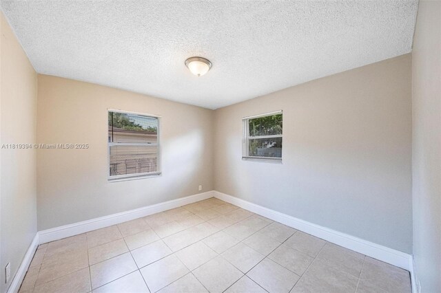 5736 Simms St, Hollywood, FL 33021 - spare room featuring a textured ceiling and light tile patterned floors