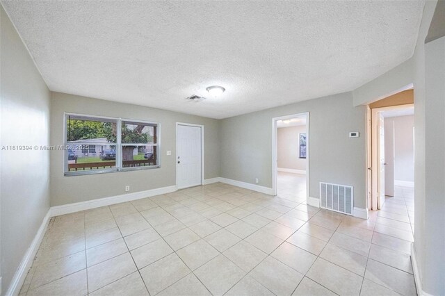 5736 Simms St, Hollywood, FL 33021 - spare room featuring light tile patterned floors and a textured ceiling