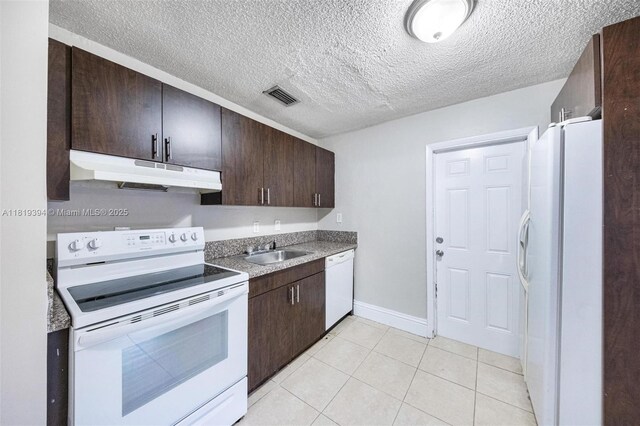 5736 Simms St, Hollywood, FL 33021 - kitchen with white appliances, under cabinet range hood, dark brown cabinets, light tile patterned floors, and a textured ceiling