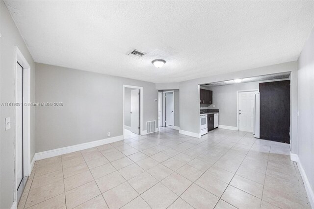 5736 Simms St, Hollywood, FL 33021 - unfurnished living room featuring light tile patterned floors and a textured ceiling