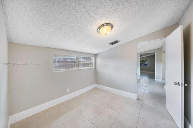 5736 Simms St, Hollywood, FL 33021 - empty room featuring light tile patterned flooring and a textured ceiling