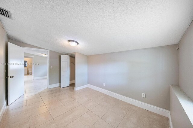 5736 Simms St, Hollywood, FL 33021 - unfurnished bedroom with a textured ceiling and light tile patterned floors