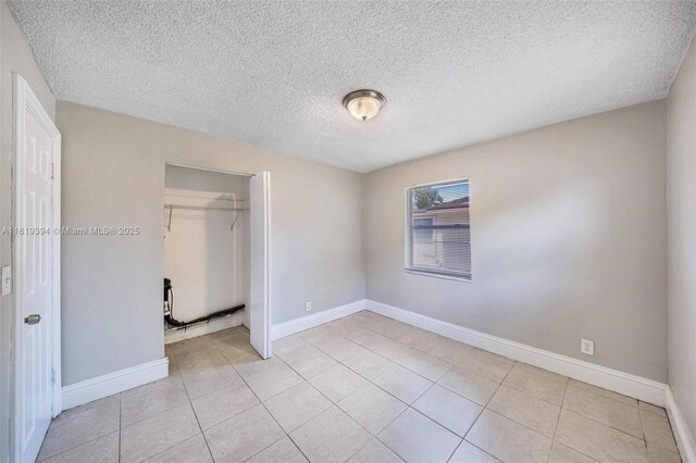 5736 Simms St, Hollywood, FL 33021 - unfurnished bedroom with a closet, a textured ceiling, and light tile patterned floors