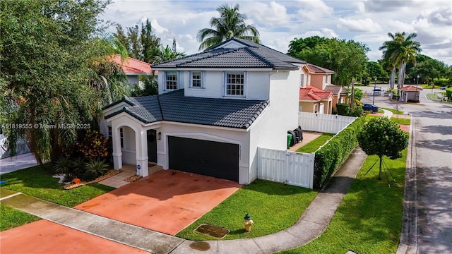 15201 SW 46th Ct, Miramar, FL 33027 - mediterranean / spanish home with a tile roof, stucco siding, driveway, and a garage