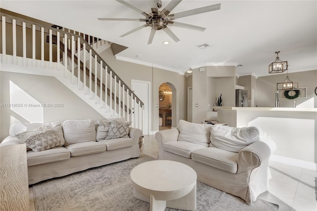 15201 SW 46th Ct, Miramar, FL 33027 - living room featuring arched walkways, tile patterned flooring, ornamental molding, ceiling fan, and stairway