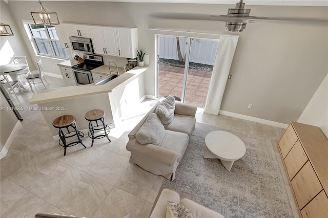 15201 SW 46th Ct, Miramar, FL 33027 - living area featuring light tile patterned floors and a chandelier