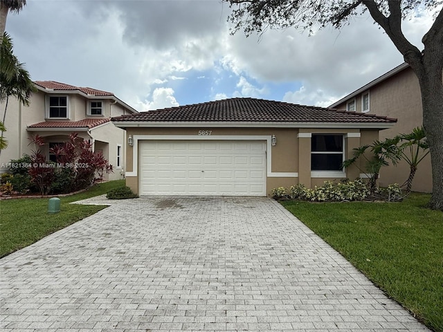 5657 NW 121st Ave, Coral Springs, FL 33076 - view of front facade featuring decorative driveway, a garage, a front yard, and stucco siding