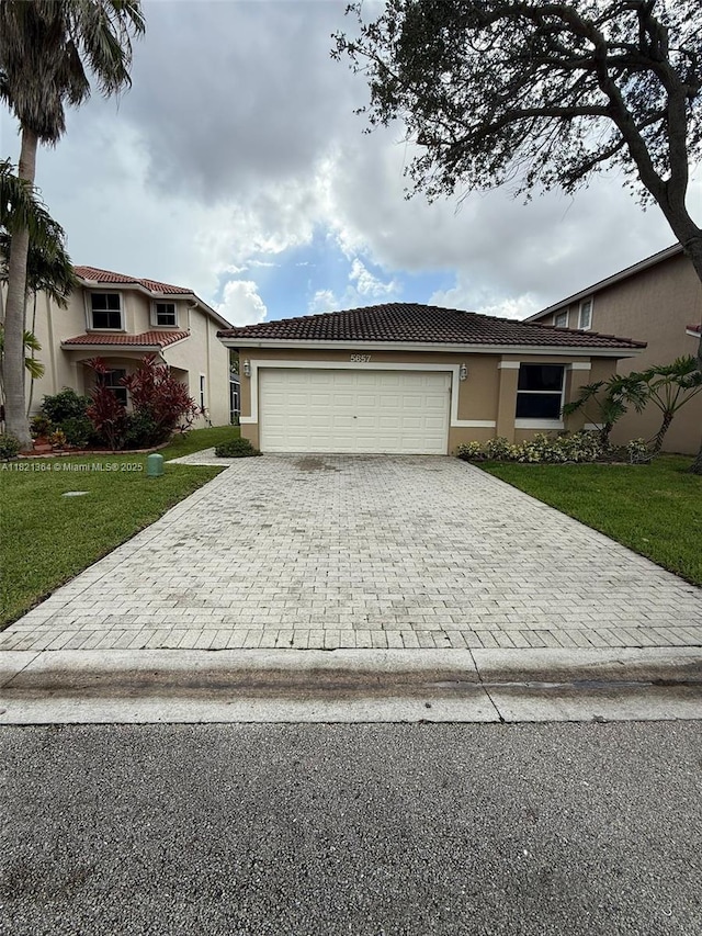 5657 NW 121st Ave, Coral Springs, FL 33076 - view of front of house featuring decorative driveway, stucco siding, a garage, a front lawn, and a tiled roof