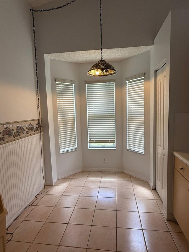 5657 NW 121st Ave, Coral Springs, FL 33076 - unfurnished dining area featuring light tile patterned floors