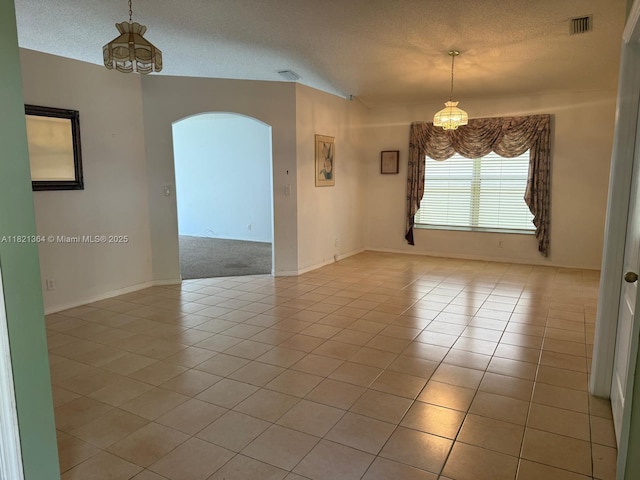 5657 NW 121st Ave, Coral Springs, FL 33076 - spare room with a chandelier, arched walkways, a textured ceiling, and light tile patterned floors