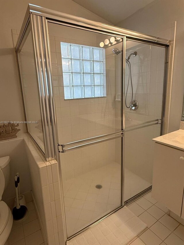 5657 NW 121st Ave, Coral Springs, FL 33076 - full bath featuring tile patterned flooring, a shower stall, vaulted ceiling, and vanity