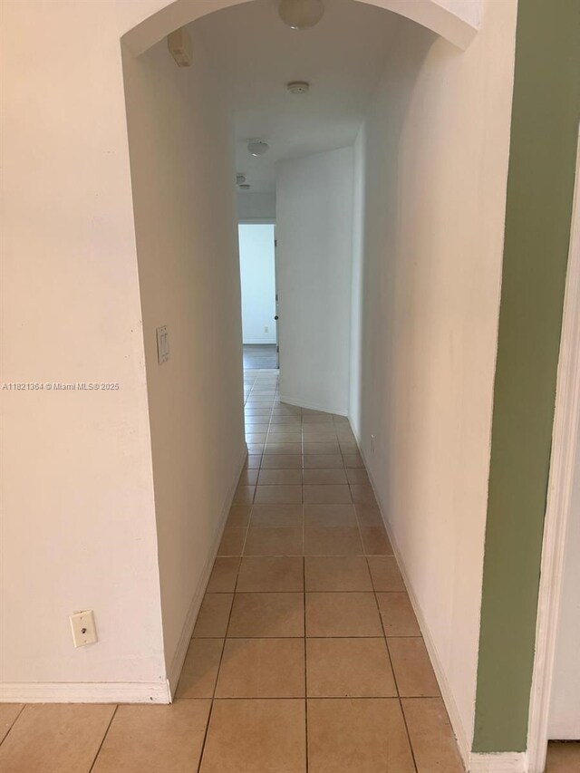 5657 NW 121st Ave, Coral Springs, FL 33076 - hallway featuring arched walkways and light tile patterned flooring