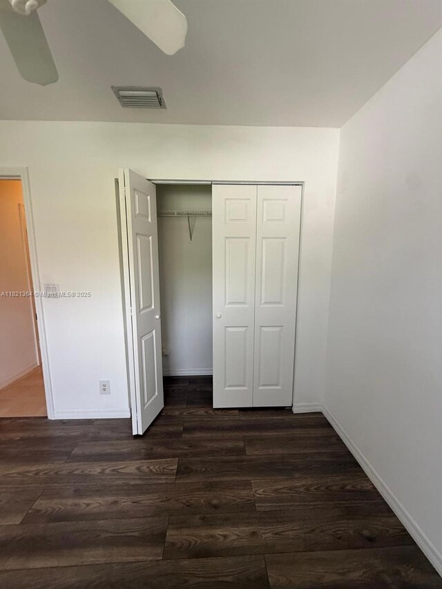 5657 NW 121st Ave, Coral Springs, FL 33076 - unfurnished bedroom featuring a closet, dark wood finished floors, and ceiling fan