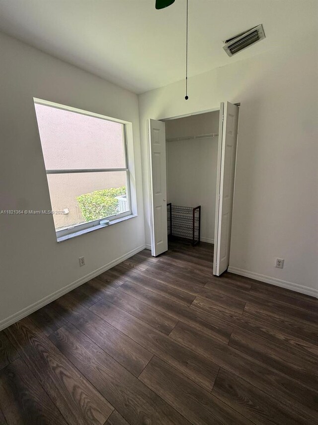 5657 NW 121st Ave, Coral Springs, FL 33076 - unfurnished bedroom featuring dark wood-style floors and a closet