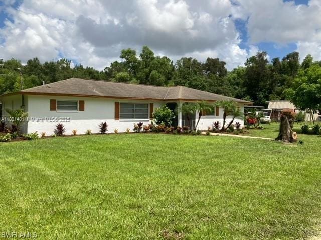 13001 Shetland Ln, Fort Myers, FL 33912 - view of front of home featuring a front lawn and stucco siding