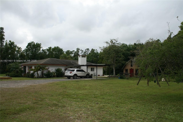 13001 Shetland Ln, Fort Myers, FL 33912 - view of front of home featuring a front yard, a chimney, and driveway