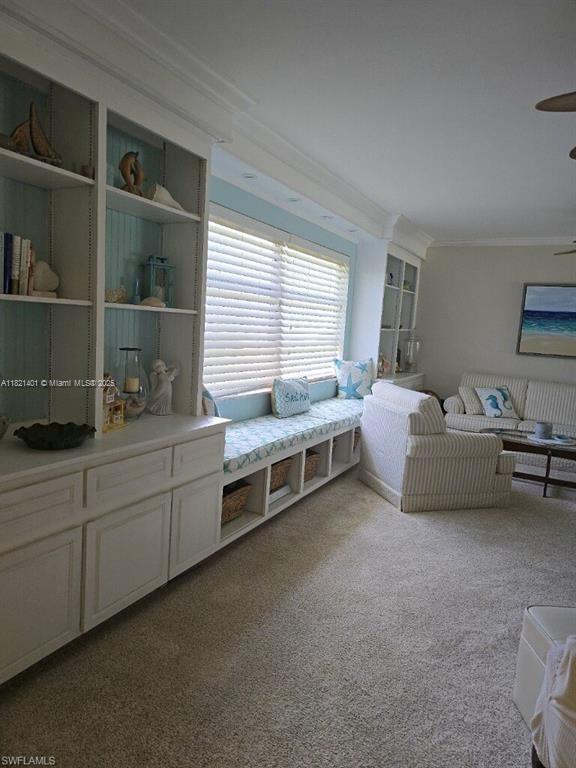 13001 Shetland Ln, Fort Myers, FL 33912 - carpeted living area with crown molding and a ceiling fan