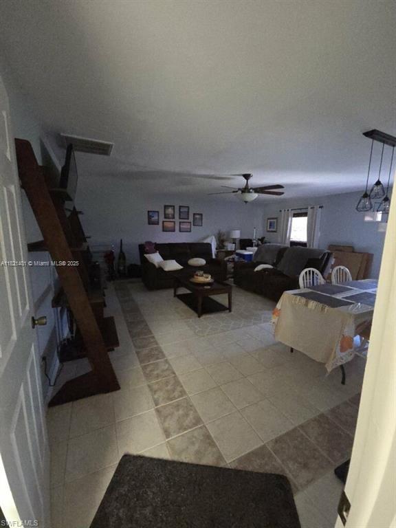 13001 Shetland Ln, Fort Myers, FL 33912 - living area with light tile patterned floors and a ceiling fan