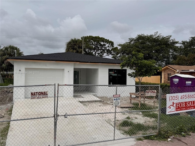2430 NW 22nd Rd, Fort Lauderdale, FL 33311 - view of front of home with a fenced front yard, a garage, stucco siding, and concrete driveway