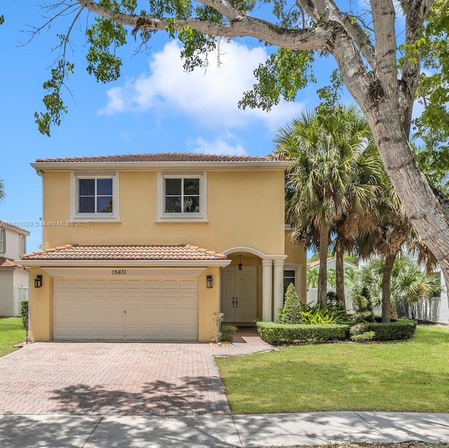 15631 SW 53rd St, Miramar, FL 33027 - mediterranean / spanish-style home with stucco siding, a garage, decorative driveway, a front yard, and a tile roof