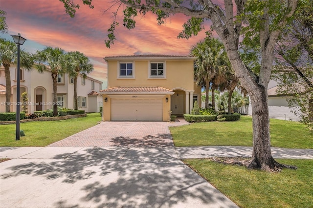 15631 SW 53rd St, Miramar, FL 33027 - mediterranean / spanish-style house featuring decorative driveway, a tile roof, stucco siding, a garage, and a lawn