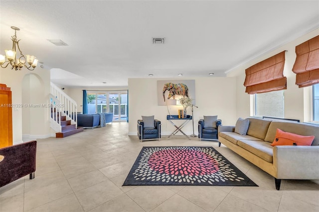 15631 SW 53rd St, Miramar, FL 33027 - living area featuring stairway, a chandelier, tile patterned flooring, and arched walkways