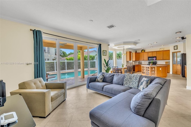 15631 SW 53rd St, Miramar, FL 33027 - living room featuring light tile patterned floors, ornamental molding, and a textured ceiling