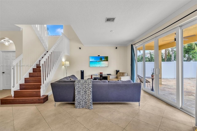 15631 SW 53rd St, Miramar, FL 33027 - living room featuring crown molding, stairs, light tile patterned floors, and a textured ceiling