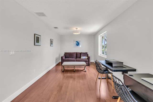 15631 SW 53rd St, Miramar, FL 33027 - living room with wood finished floors, a desk, and a textured ceiling
