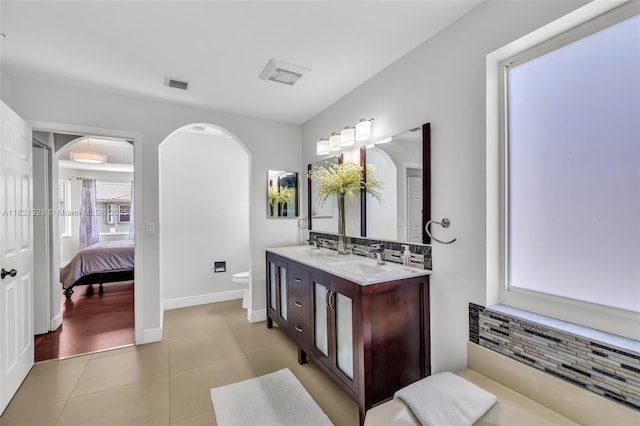 15631 SW 53rd St, Miramar, FL 33027 - bathroom featuring double vanity, decorative backsplash, tile patterned floors, and ensuite bathroom