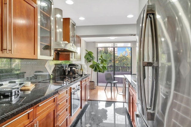 201 Crandon Bl Unit 200, Key Biscayne, FL 33149 - kitchen featuring appliances with stainless steel finishes, wall chimney exhaust hood, tasteful backsplash, tile counters, and glass insert cabinets