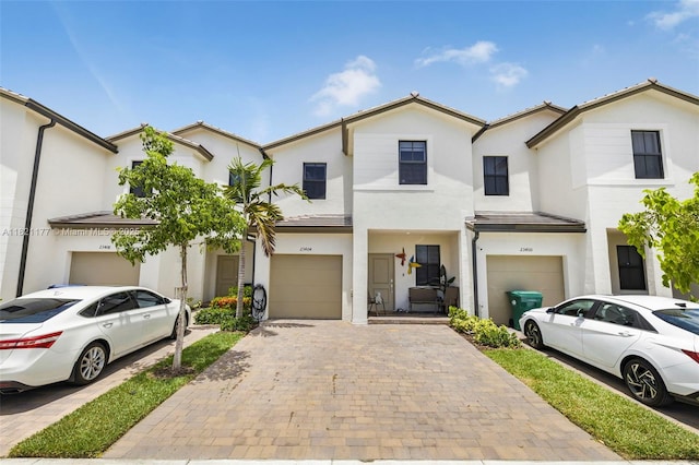 23404 SW 131st Ave, Homestead, FL 33032 - townhome / multi-family property with an attached garage, stucco siding, and decorative driveway