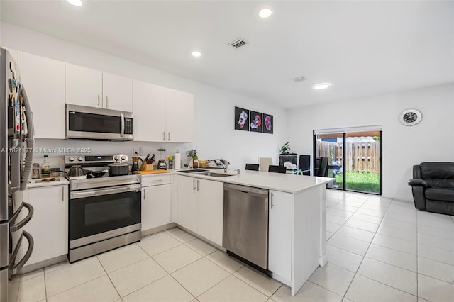 23404 SW 131st Ave, Homestead, FL 33032 - kitchen featuring appliances with stainless steel finishes, a peninsula, open floor plan, light countertops, and recessed lighting