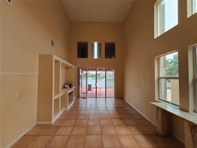 15651 NW 14th Ct, Pembroke Pines, FL 33028 - spare room with a towering ceiling and light tile patterned floors