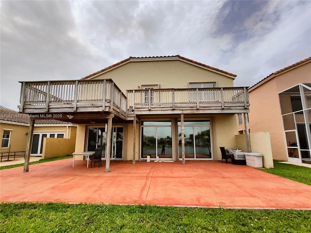 15651 NW 14th Ct, Pembroke Pines, FL 33028 - back of house featuring a patio, stucco siding, and a wooden deck
