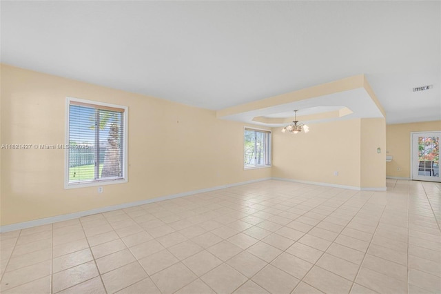 21343 SW 88th Ct, Cutler Bay, FL 33189 - unfurnished room with a chandelier, light tile patterned floors, and a raised ceiling