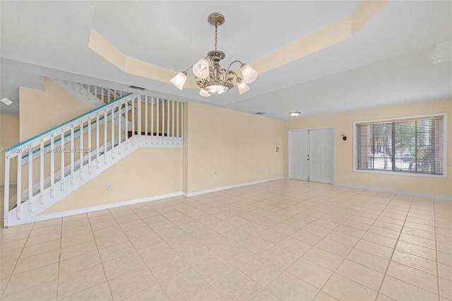 21343 SW 88th Ct, Cutler Bay, FL 33189 - unfurnished living room with a chandelier, a raised ceiling, stairway, and light tile patterned flooring
